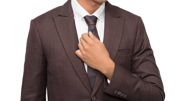 Businessman arranging his tie on white background