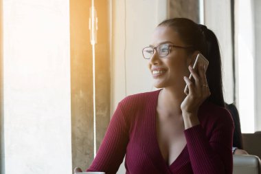 Mutlu kadın coffeeshop içinde smartphone kullanıyorsanız