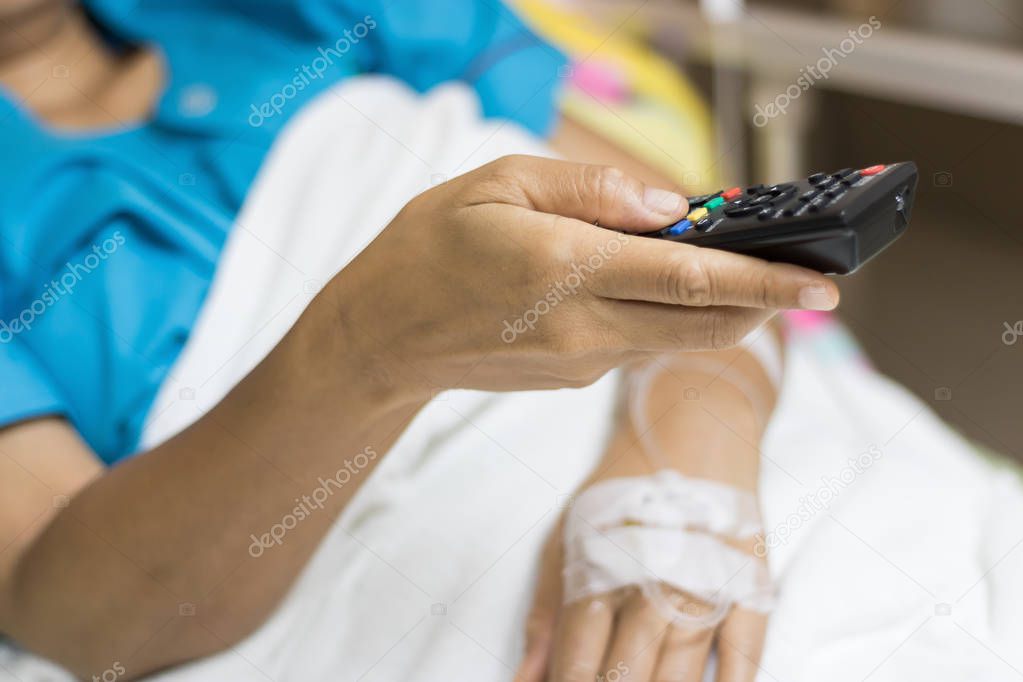 Close up of inpatient woman's Hand are using remote control for 