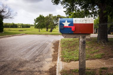 Mailbox painted with the Texas Flag in a street in Texas clipart