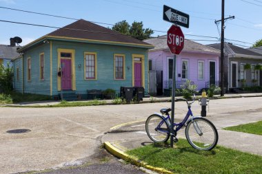 Bir satır bir sokakta Louisiana, New Orleans şehri renkli evlerin önünde bir dur işareti bir bisiklet park.
