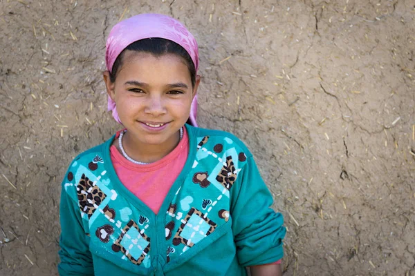 Genç Berber kız pozlar Ziz Vadisi'nde Errachidia, Fas yakınındaki küçük bir Berber köy evinde önünde.