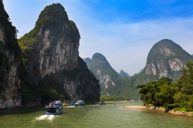 Passenger boats and rafts in the Li River in the Guagxi Region in China clipart