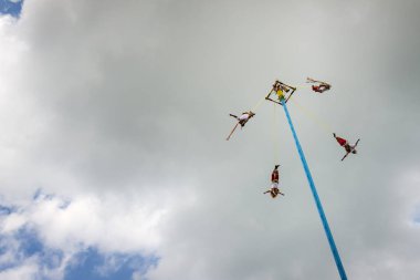 Man performing the Dance of the Flyers (Danza de Los Voladores) in the El Tajin, Mexico. clipart