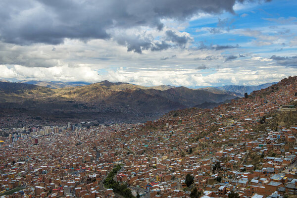 The city of La Paz seen from El Alto and the surrounding mountains on the background, in Bolivia