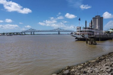 New Orleans, Louisiana - 17 Haziran 2014: Mississippi Nehri üzerinden New Orleans şehri riverfront bir Mississippi vapur ve New Orleans, Louisiana arka planda büyük New Orleans köprüde görünümünü.