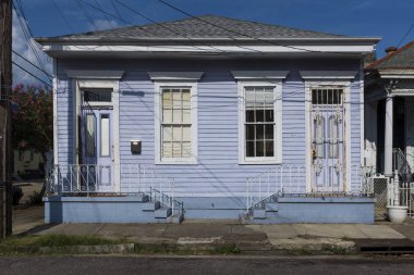 The facade of a traditional colorful house in the Marigny neighborhood in the city of New Orleans, Louisiana, USA clipart