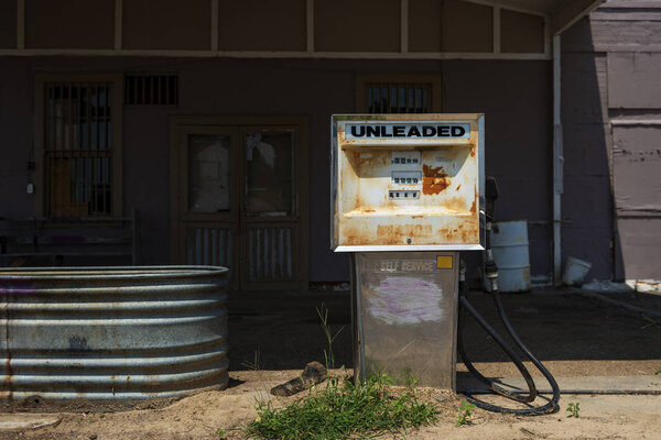 Old and rusty fuel pump in an abandoned gas station in the USA; Concept for fossil fuel, and global warming