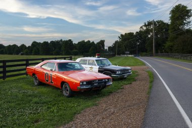 Tennessee, USA - June 26, 2014: Replicas of the General Lee Charger and the Sheriff car, from the television series The Dukes of Hazzard, parked along a country road in the State of Tennessee.