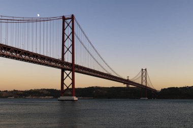 Portekiz 'in Lizbon şehrindeki Tagus Nehri üzerindeki 25 Nisan Köprüsü (Ponte 25 de Abril) manzarası; Portekiz' e seyahat kavramı