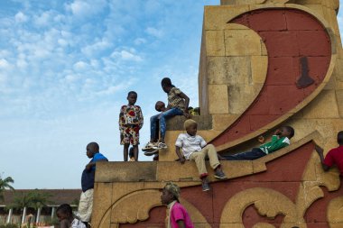 Bissau, Gine-Bissau Cumhuriyeti - 10 Şubat 2018: Batı Afrika 'nın Gine-Bissau kentindeki Herois Nacionais Adaları' ndaki bir heykelde oynayan çocuklar