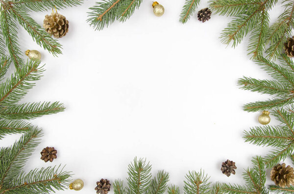 Christmas frame fir branches, cones and golden balls. Christmas wallpaper. Flat lay, top view. Mockup