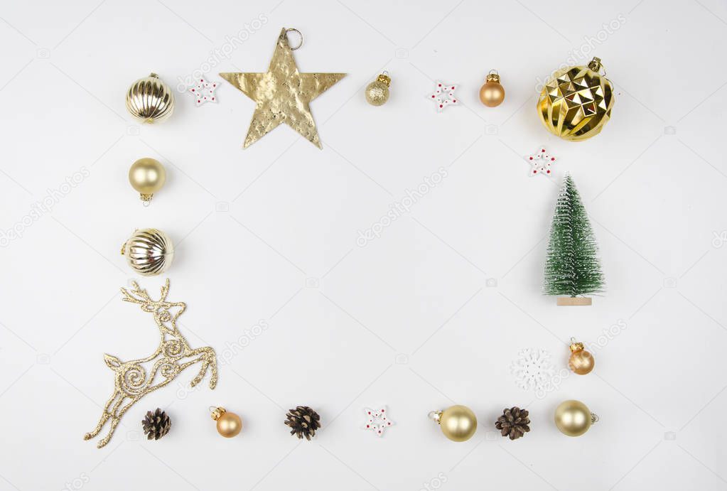 Christmas composition. Frame made of christmas decoration, christmas deer, balls, cones, golden star and fir tree. Flat lay, top view. Trendy mockup