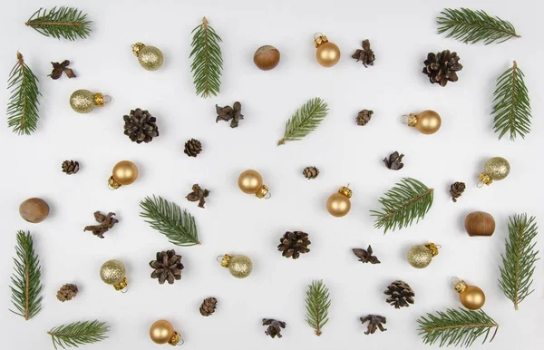 Composizione natalizia. Modello realizzato con rami di pino e decorazioni natalizie su sfondo bianco. Posa piatta, vista dall'alto — Foto Stock