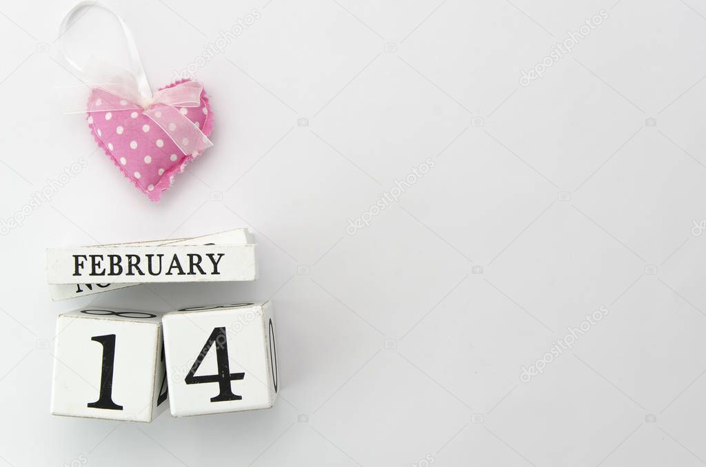 14 February wood calendar with pink heart on top Valentines Day card mockup. Flat lay. Copy space