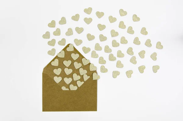 Valentine Day greeting card envelopes with heart. Golden hearts pours out of the envelope isolated on white. Hearts fly out from the envelope. Love Letter.