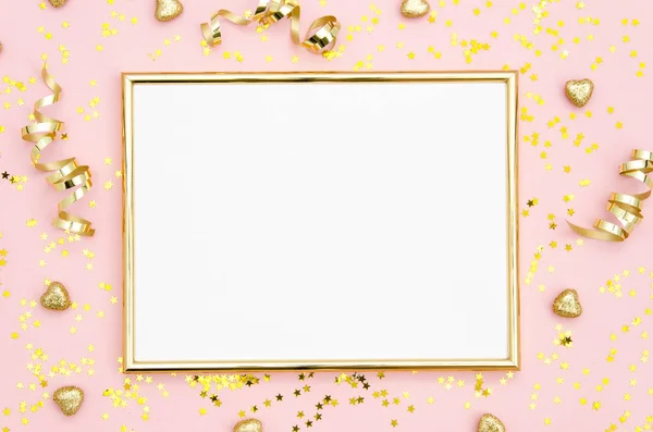 Photo frame mock up with space for text, golden sequins confetti on pink background. Lay Flat, top view. Valentines minimal flatly background.