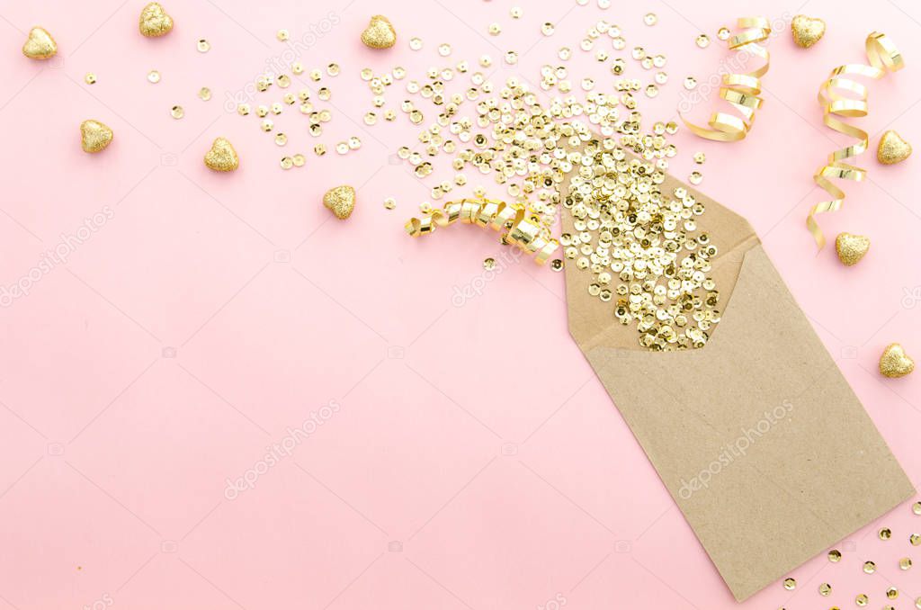 Envelope with gold glitter sequins, confetti and hearts on a gently pink background. Mockup template. View from above