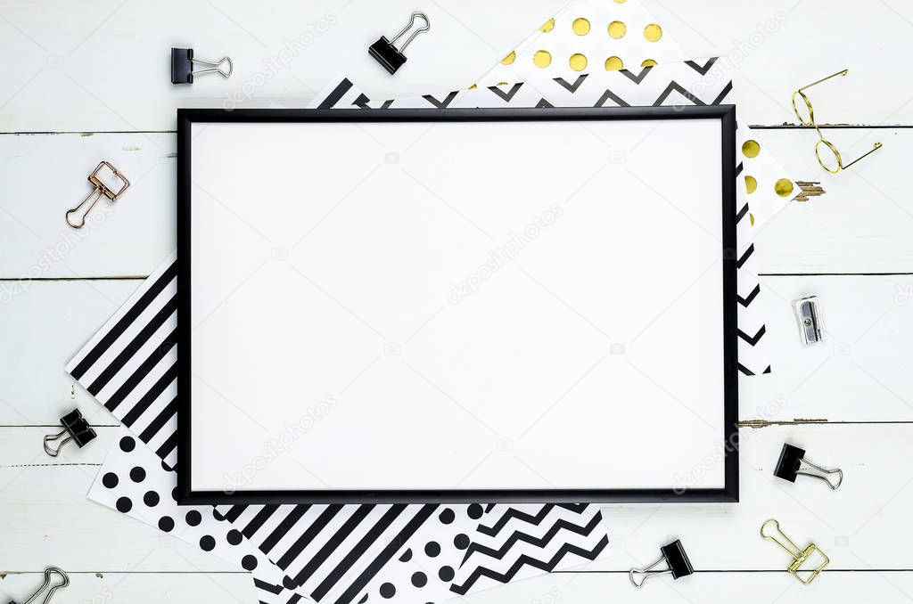Flat lay mockup with black frame, and office supplies on white wooden background. Top view mockup. Blog template