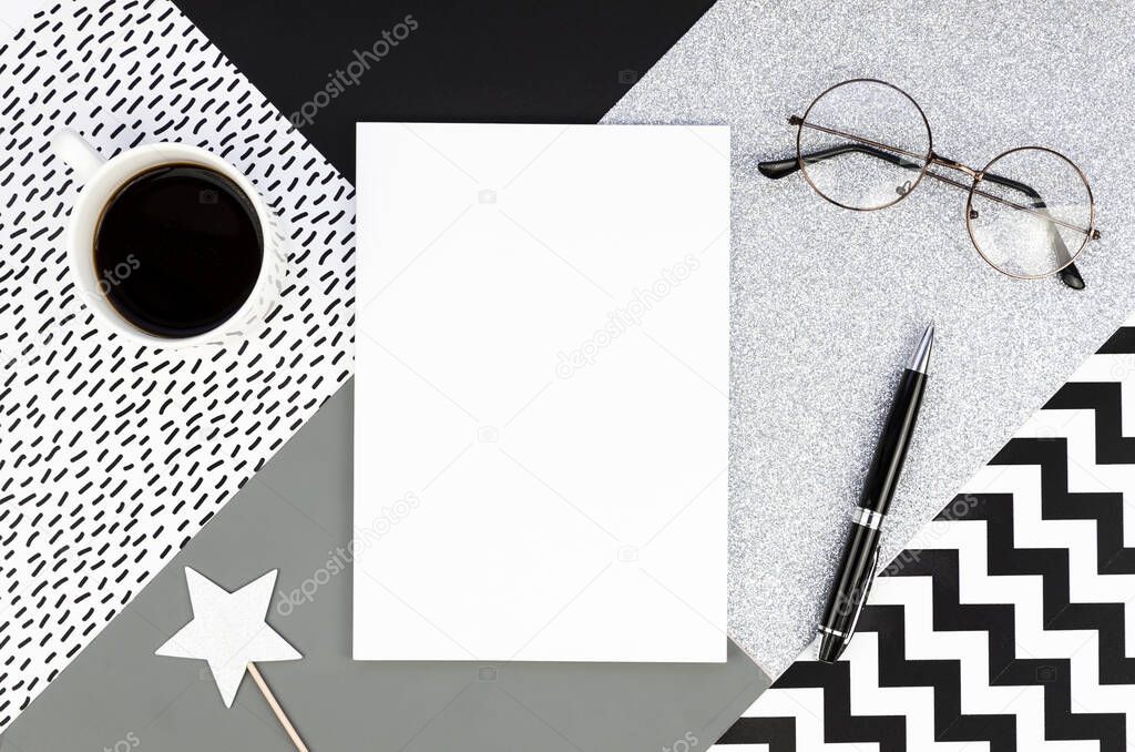 Black and white concept. Top View Office Desk with coffee,blank notebook, glasses and silver stars. Clean minimal post background mockup.