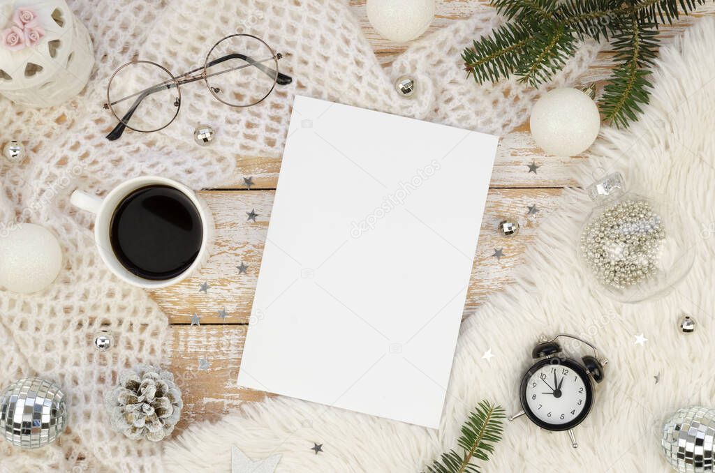 Magazine Cover mockup flat lay with Cup of black coffee, alarm clock, Christmas decoration and fir branches on a white rustic wooden background. Winter female magazine concept