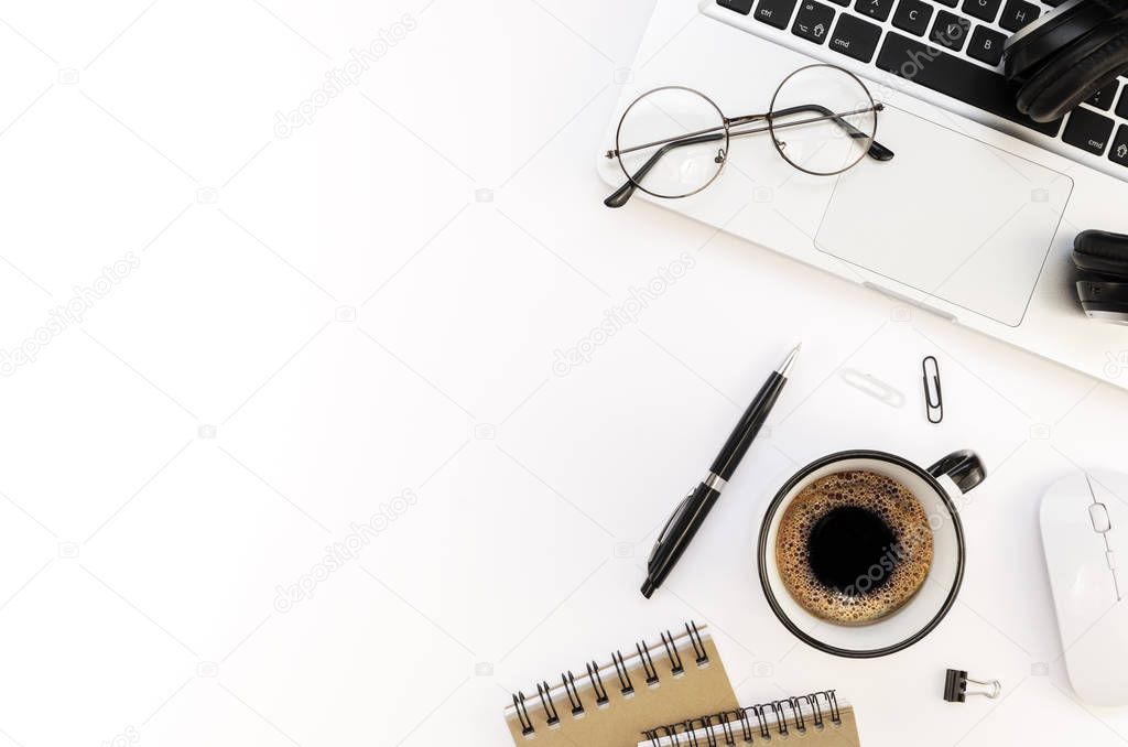 Flat lay programmers workplace white table with silver laptop and coffee cup. Top view International Programmers Day concept with pen, spiral notebook and copy space for your text
