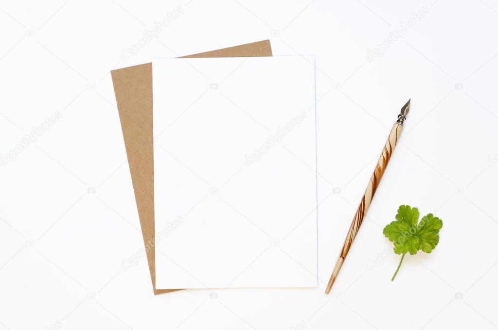 Top view minimal Desktop workplace designer or handwriting writer. Mockup paper with space for text, ink paper and three-leaf clover for good luck