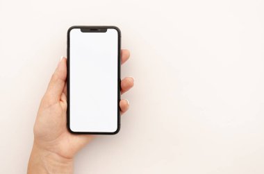 Kadın eli siyah iPhone X 'i boş ekranla tutuyor. Ekran görüntüsü uygulama modeli için yer. Beyaz arkaplanda ön görünüm