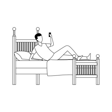 Yatakta cep telefonu kullanan bir adam.