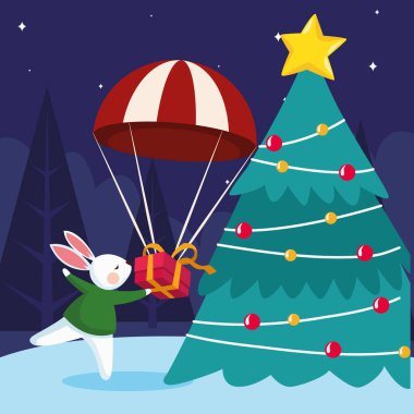 Noel ağacı etrafında hediye kutusu ve tavşan olan bir paraşüt.