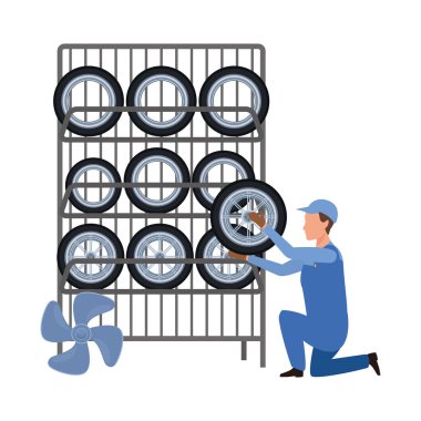 Araba tamircisi lastik askısı tutuyor.