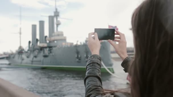 Meisje dat neemt foto's van de kruiser Aurora St. Petersburg — Stockvideo