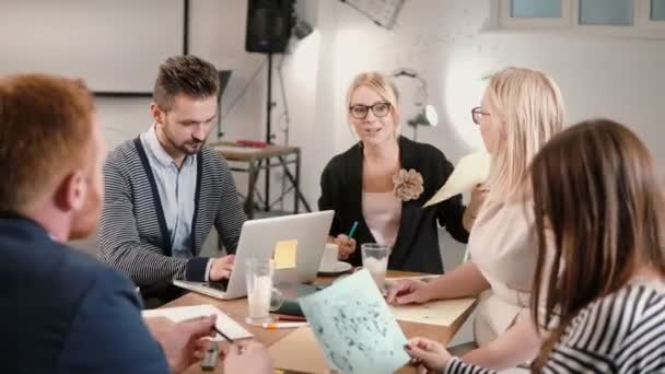 Equipo creativo de negocios en la mesa en una moderna oficina de startups. Líder femenina explica los detalles del proyecto . — Vídeos de Stock