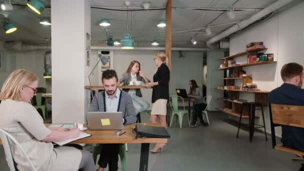 Man working on laptop discovers good news everyone is happy congratulate and applaud him business team in startup office — Stock Video