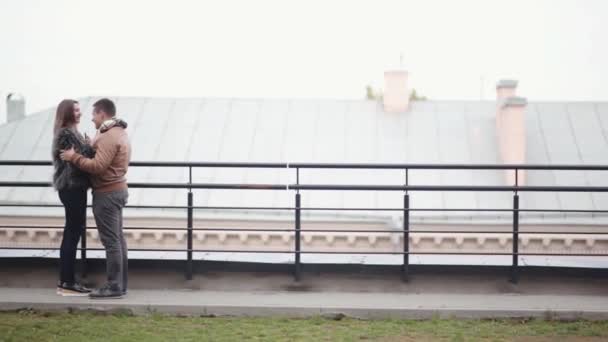 Happy man and woman in love cheerfully laugh, talk, hug each other on a roof. Happy moments with our loved ones. — Stock Video