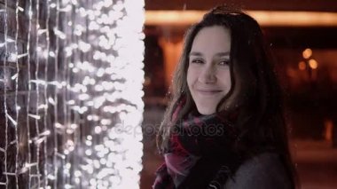 arka plan kamera ışıklara bakarak Noel gece yağan kar genç çekici kadın