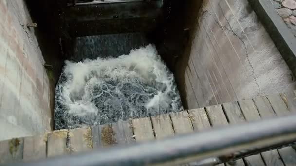 Una vista desde la parte superior de un puente de madera con barandas de hierro forjado en un molino de agua — Vídeo de stock