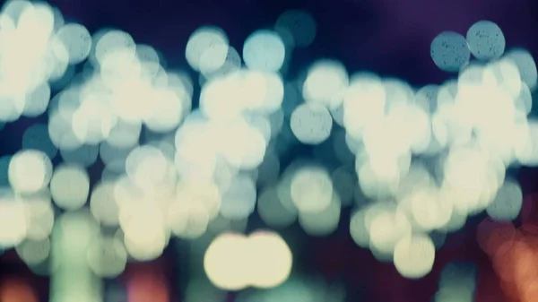 Colorful, blurred, bokeh lights background in cold tones. Abstract sparkles. — Stock Photo, Image