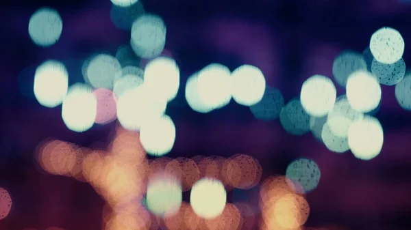 Colorful, blurred, bokeh lights background in cold tones. Abstract sparkles. — Stock Photo, Image