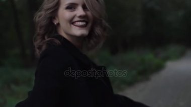 Bir adamın elini tutarak doğada çalışırken kadın yüzünü esirgemezdin kamera döner. Sarı saçlı sallanan.