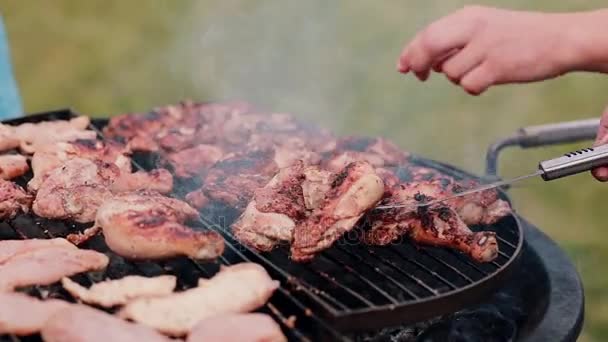 Mans cozinhar frango em churrasqueira ao ar livre. A fumaça que vem do churrasco . — Vídeo de Stock