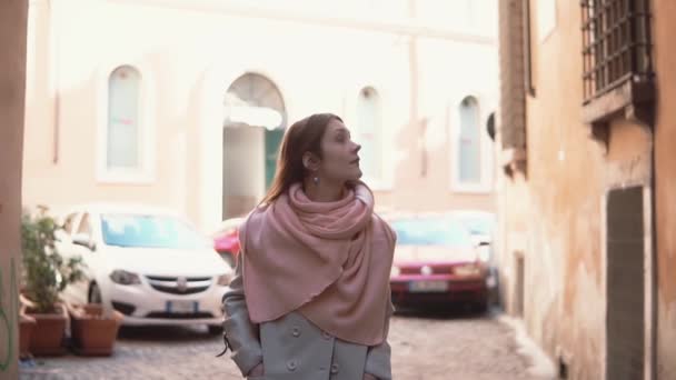 Traveling girl with backpack walking through the little street. Young woman exploring the old city, looking around. — Stock Video