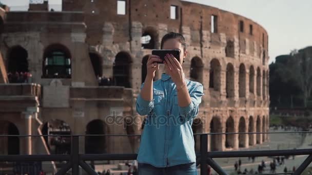 En ung turist kvinna tar selfie foto på Colosseum i Rom. med smartphone ler, skrattar. Slow motion. — Stockvideo