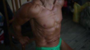 Genç atletik eğitim ön kolda, pazı ve triceps adam. O çalışıyor. Vücut geliştirmeci rekabet arka plan.