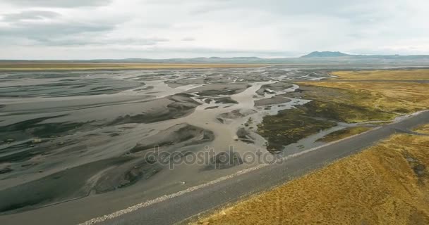 Aerial view of the valley with melting glacier on it and mountains. Beautiful landscape of Icelandic nature. — Stock Video