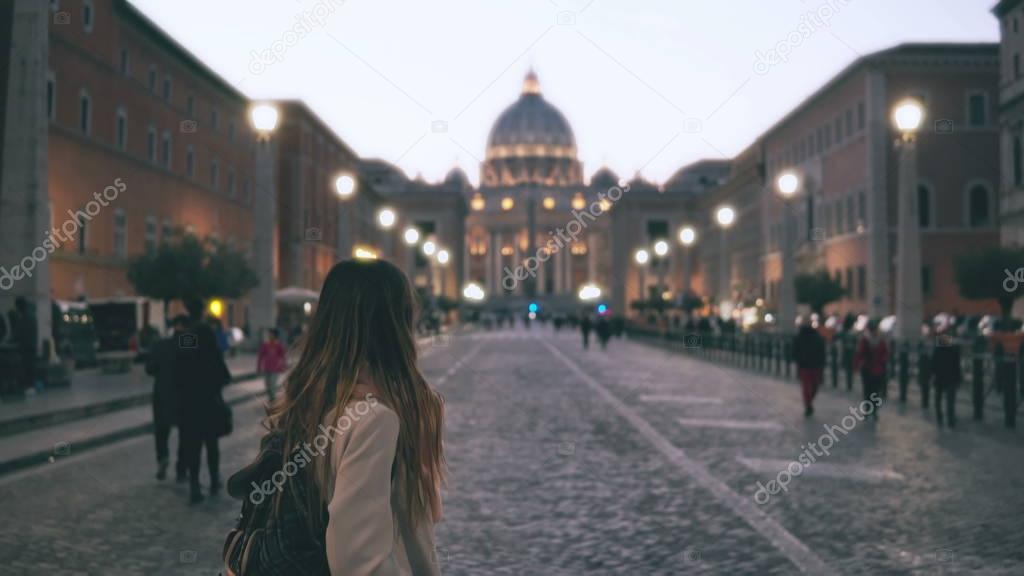 Young beautiful woman walking in Piazza di spagna in Rome, Italy. Girl goes to Saint Peter Cathedral. Slow motion.