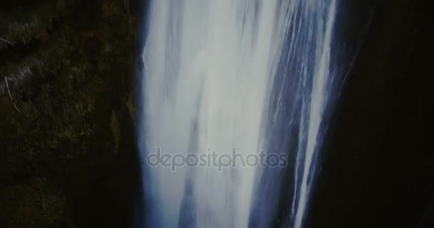 Aerial view of the turbulent flow of water falls down from the top of the mountain. Waterfall Gljufrabui in Iceland. — Stock Video