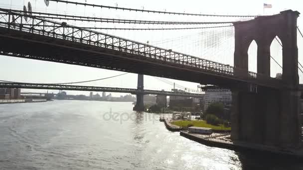 Aerial view of the New York, America. Copter flying under the Brooklyn bridge to Manhattan bridge through East river — Stock Video