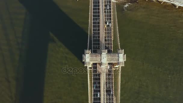 Top aerial view of the traffic road on the Brooklyn bridge through the East river in New York, America. — Stock Video