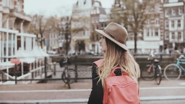 Pretty lady crosses street talking on the phone. 4K. Young creative happy female businesswoman talks on a river bridge. — Stock Video